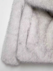 Detailed close-up showing the soft texture and stitching of this grey faux fur jacket