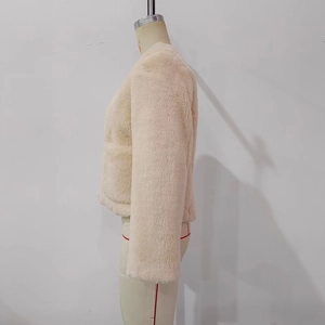 Detail of beige faux fur jacket showing thick plush texture on a fashion mannequin