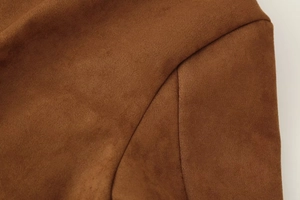 Macro shot of the brown faux suede fabric showing soft texture and matte finish