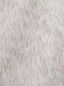 Detail of high-density faux fur material in grey and white with soft long fibers