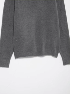 Detail of dark grey knit fabric showing ribbed cuffs and hem with soft wool-like texture