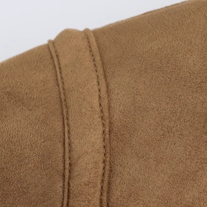 Macro shot of brown suede jacket showing double stitching detail and fine matte texture