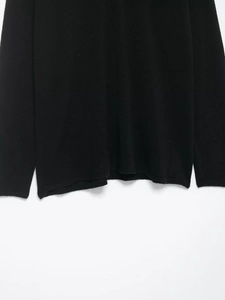 Detail of the hem and cuffs on this black V-neck lace patchwork wool blend knit top