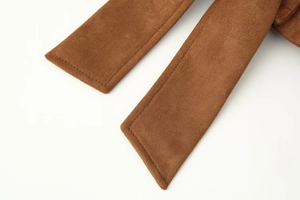 Detail of premium brown faux suede fabric with fine stitching and soft texture