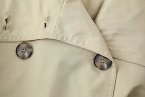 Detailed shot of lapel collar and classic tortoiseshell buttons on khaki twill jacket