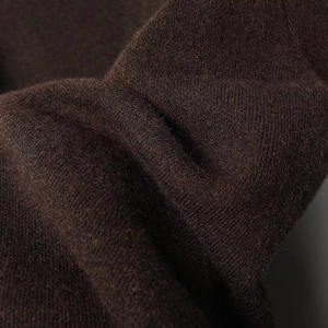 Close-up of premium coffee brown knitted fabric with soft wool texture and fine details