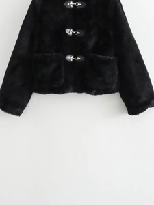 Close-up of black faux fur jacket featuring silver metal toggle buttons and leather patches