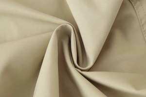 Detailed macro shot of khaki twill woven fabric for double-breasted short trench coat