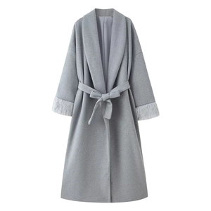 Women's long light grey wool coat with elegant tie-up waist and faux fur cuffs