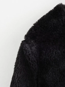 Detailed close-up of high-density black faux fur texture on a winter fleece jacket