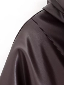Macro shot of faux leather texture and precise stitching on dark brown stand collar jacket