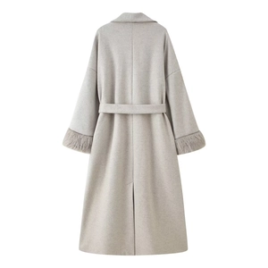 Detailed back view of a grey wool coat featuring fur cuffs and a belted waist design
