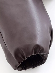 Close-up of elastic cuffs on dark brown leather jacket with fine grain texture details
