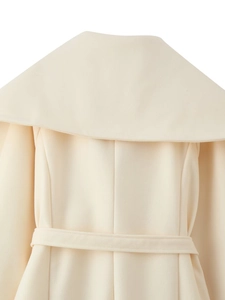 Detail view of the elegant ivory wool coat back with waist belt and large lapel collar