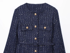 Detailed view of navy blue tweed jacket with sequin weave and vintage gold buttons