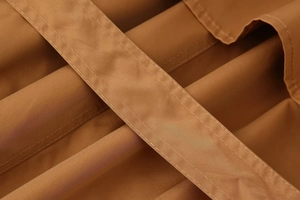 Macro detail of high-density khaki twill fabric and precision double stitching on a trench coat