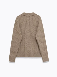 Detail of classic cable-knit texture and turn-down collar on brown knitted sweater