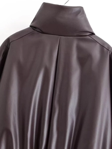 Detail view of the brown faux leather jacket featuring a stand collar and vertical back stitching