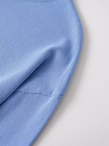 Close-up of the sky blue crew neck and fine knit texture on this long sleeve casual top