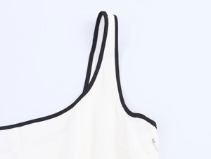Detail view of contrast black piping on white square neck dress with invisible side zipper