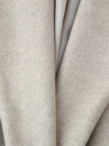 Detailed macro view showing the high-quality wool fabric texture and smooth silk lining