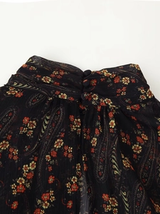 Detail of floral paisley mini dress featuring high neck collar and back button closure
