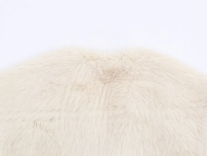 Macro close-up showing thick, fluffy texture of the off-white faux fur vest material
