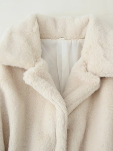 Detailed close-up of premium light beige faux fur coat with soft texture and inner lining