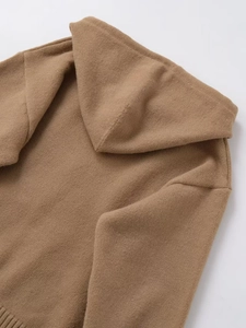 Detail of brown knitted hoodie showing hood texture, shoulder seams, and ribbed hem