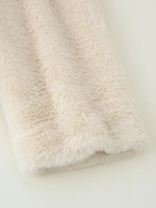 Close-up of premium cream faux fur coat showing dense plush texture and soft long hair