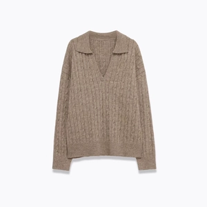 Brown knit sweater with classic cable pattern and V-neck collar shown in flat lay view