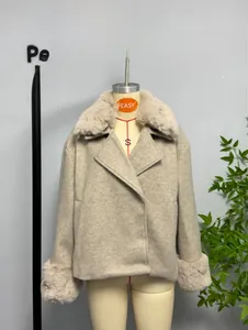 Detailed view of elegant faux fur collar and cuffs on a beige short wool coat