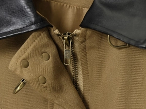 Detail of cargo jacket with black leather collar and vintage bronze metal zipper