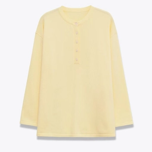Women's cream waffle knit henley shirt with five buttons and loose long sleeves