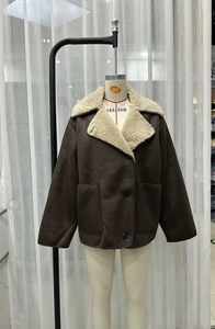 Detailed view of the dark brown faux shearling jacket with large lapels and front pockets