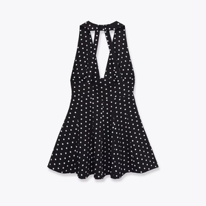 Polka dot halter neck dress with crisscross back straps and a retro A-line silhouette