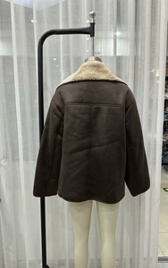 Detail of dark brown faux shearling jacket with visible contrast stitching on the back