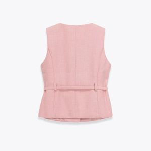 Detailed back view of a pink tweed vest showing tailored seams and a fixed waist belt