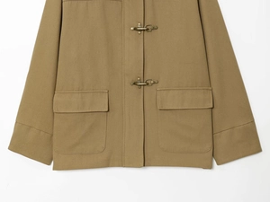 Detailed macro of utility jacket with metal lobster buckles and large flap pockets