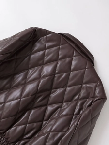 Detail of dark brown quilted faux leather jacket with large diamond stitch texture