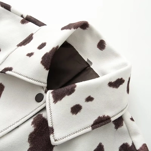 Chic cow print wool jacket with classic lapel collar and matte black button detail