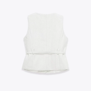 Detail view of tweed peplum top back featuring fine weave texture and thin waist belt