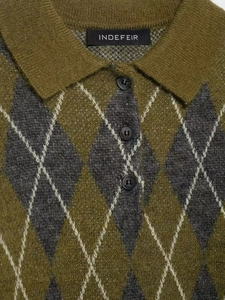 Close-up of polo collar and argyle knit pattern in olive and grey with three dark buttons