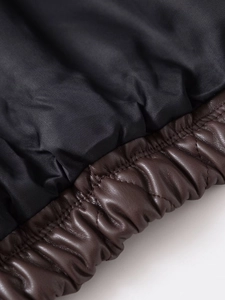Detail of dark brown PU leather jacket featuring elastic smocked hem and smooth silk lining
