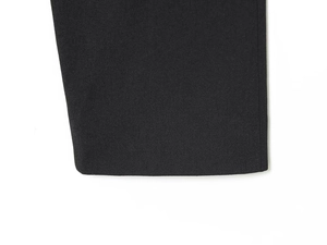 Close-up of the thick black wool fabric and detailed stitching on the sleeve cuff