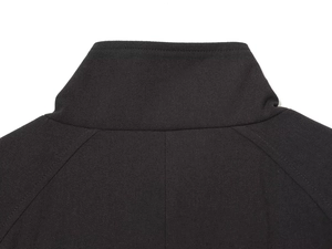 Detailed close-up of the standing collar and raglan sleeve seams on a black wool coat