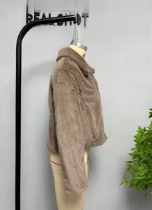 Detail of a brown faux fur jacket showing the plush texture and large lapel collar design