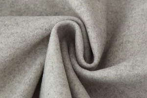 Macro view of grey wool-like fabric texture showing soft fibers and thickness on short coat