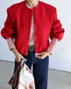 Detail view of red round neck zip jacket with puff sleeves and drop shoulder design