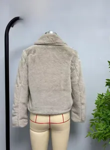 Detail view of the short faux fur jacket back on a mannequin in light grey color